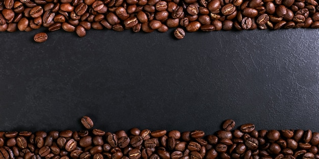 Aroma roasted coffee beans on rustic tabletop, brown banner background.