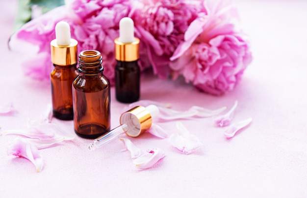 Aromatherapy essentials oils and pink peonies