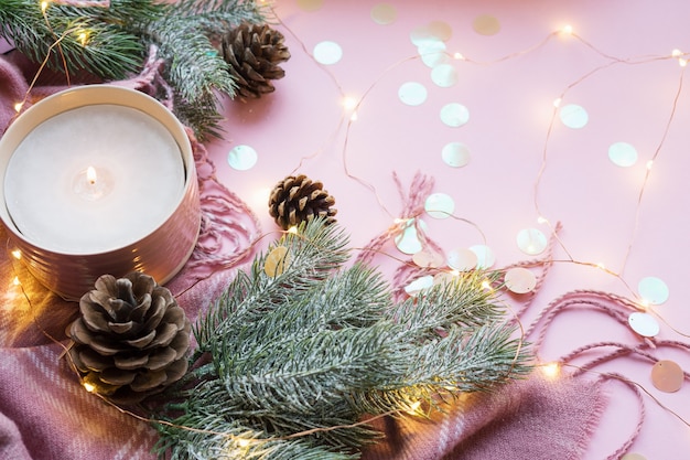 Aromatic burning candle and fir branches