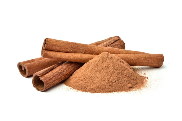 Aromatic cinnamon powder with sticks isolated on white