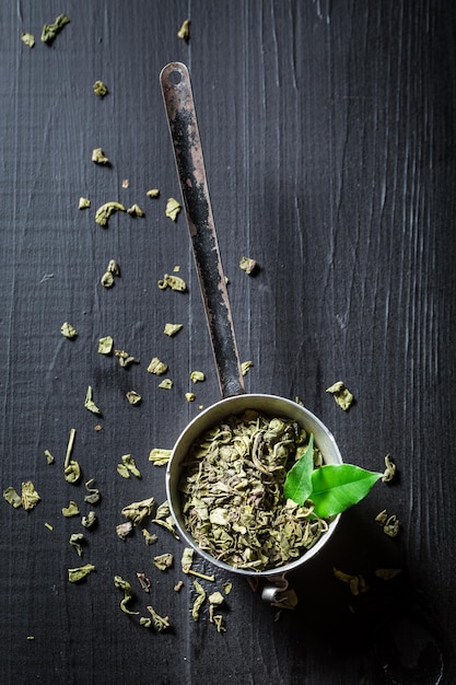 Aromatic green tea on black wooden table