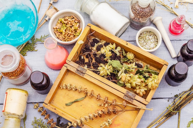 Aromatic herbs, spices and seeds in jars and wooden box