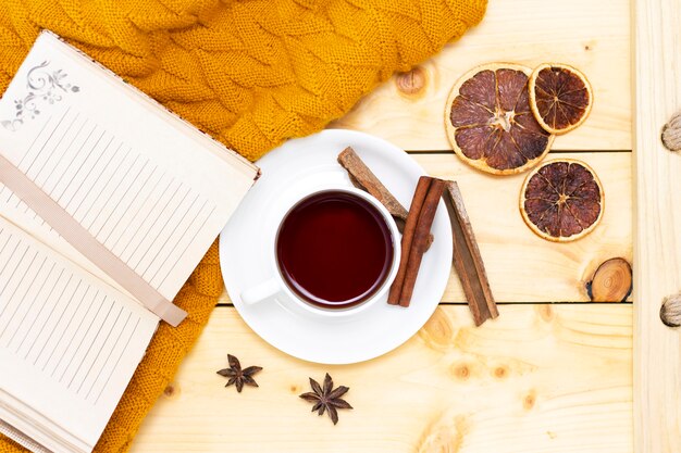 Aromatic hot cinnamon tea covered with a warm scarf