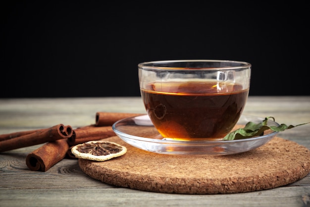 Aromatic hot cinnamon tea on wooden table