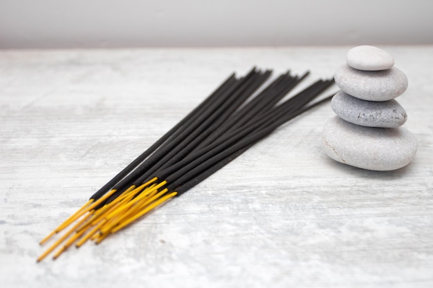 Aromatic incense sticks and pebbles.