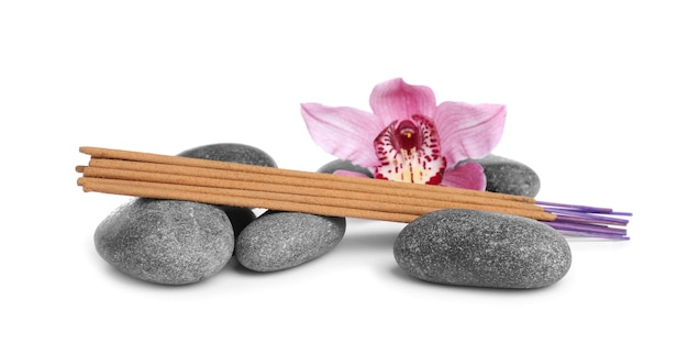 Aromatic incense sticks spa stones and orchid flower on white background