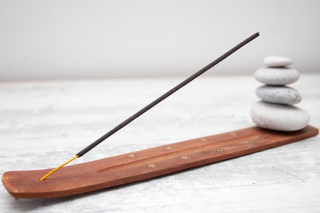 Aromatic incense sticks on wooden stand.