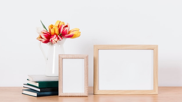 Arranged blank photo frames and flowers