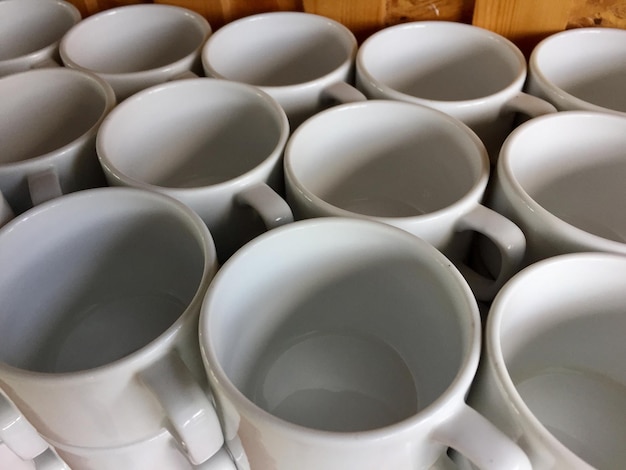 the arrangement of ceramic glasses neatly lined up on a shelf