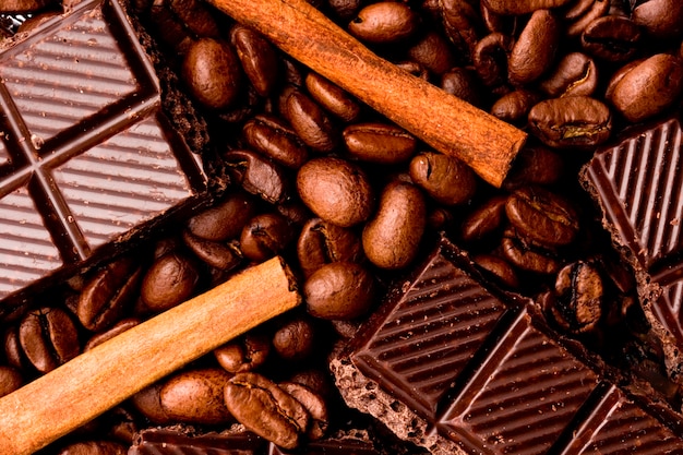 Arrangement of chocolate, coffee and cinnamon sticks  closeup