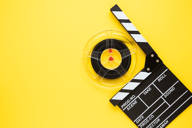 Photo arrangement of cinema elements on yellow background with copy space