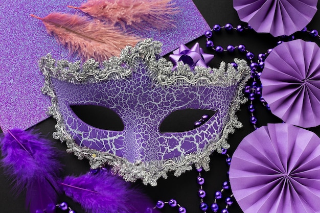 Arrangement of elegant violet mask and decoration