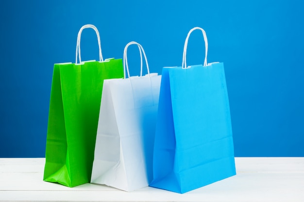 Arrangement of shopping bags on blue background