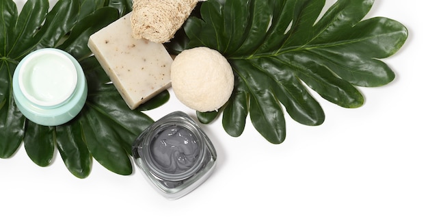 Arrangement of skin care products with palm leaves