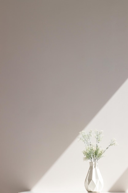 Arrangement wildflowers in vase on white table