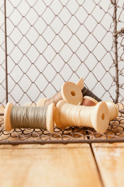 Arrangement with thread on wooden table