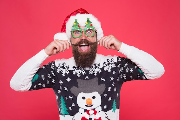 Arrive in style to Chritmas events. Bearded man in santa claus style. Happy hipster twirl mustache. Festive holiday style. Christmas and new year celebration. Fashion for winter. Celebrate in style.