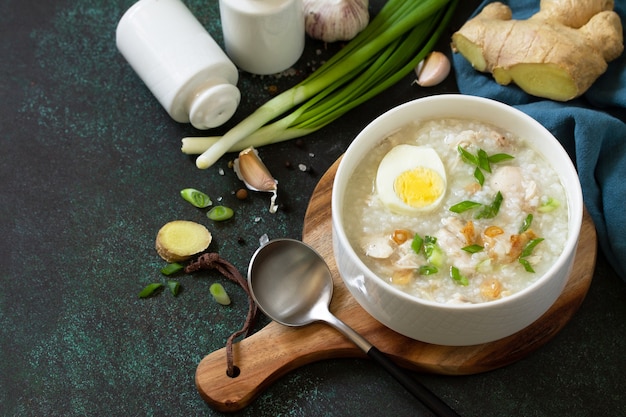 Arroz Caldo Soup Hot soup with ginger chicken rice and garlic Copy space