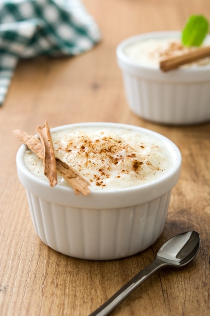 Arroz con leche Rice pudding with cinnamon on wood