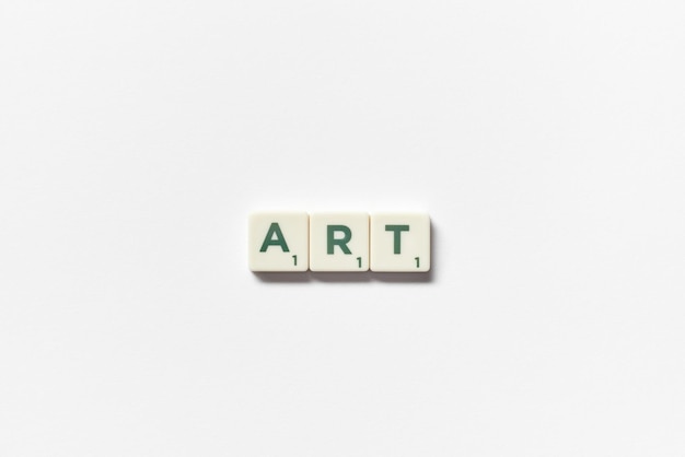 Art formed of scrabble tiles on white background