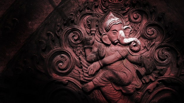 Art of hinddu religion on cement figure on red brick at public temple in Thailand