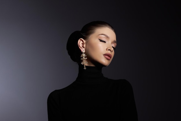 Art portrait woman in black turtleneck Hair high beam perfect profile face Elegant beauty style Earrings in the ears