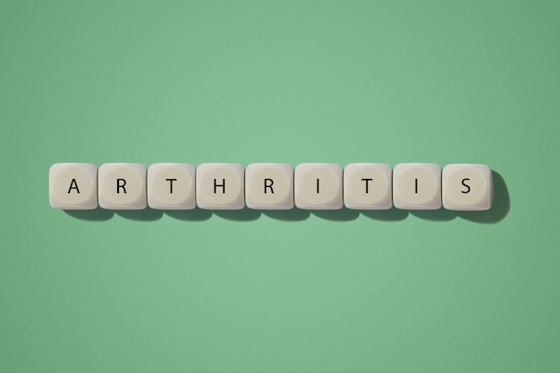 Arthritis inscription On wooden cubes On a green background