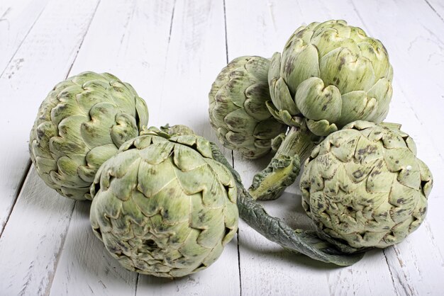 Artichokes on white planks