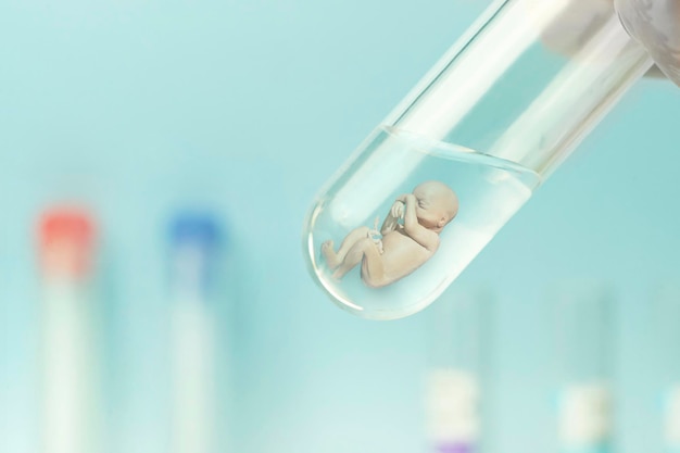 Artificial insemination Test tube baby IVF A human embryo in a glass tube on a blue laboratory background concept of artificial insemination or human cloning