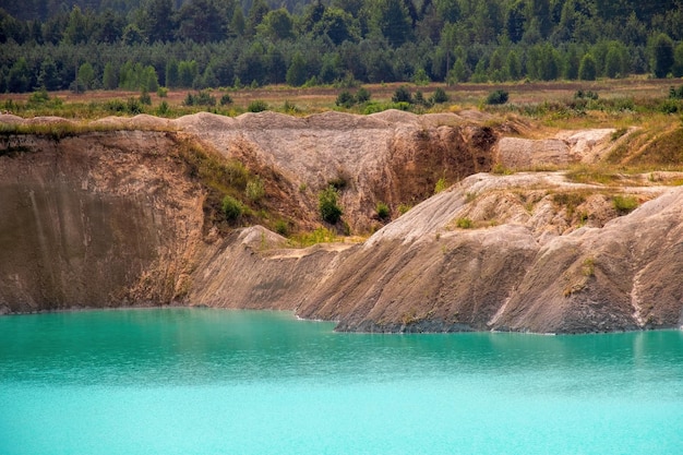 Artificial lake in a chalk quarry with turquoise background of the clear water in summer season in outdoors Technogenic mountains formed during chalk mining