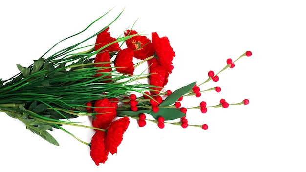 Artificial red flowers and green leaves isolated