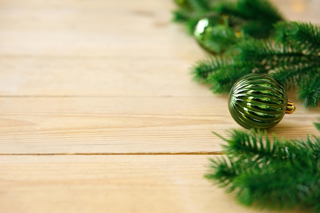 Artificial spruce branches and Christmas tree toys balls on rough wooden boards Floor covering