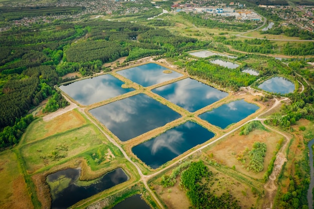 Artificial storage ponds for treating city water. nature of the reflection of the sky in the water. View from above