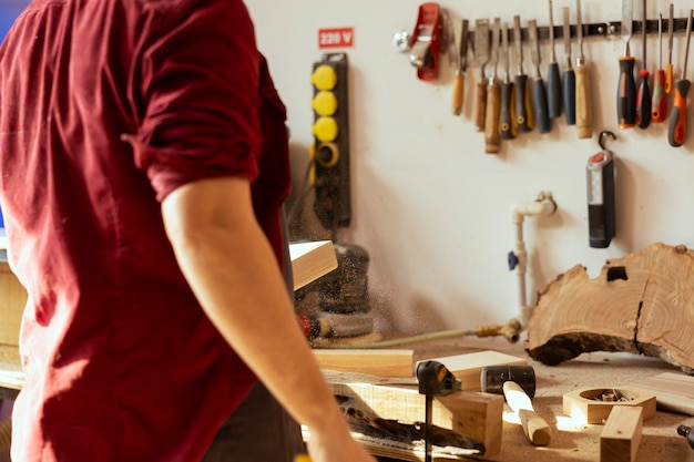 Artisan working in studio using sanding block to remove imperfections on wood