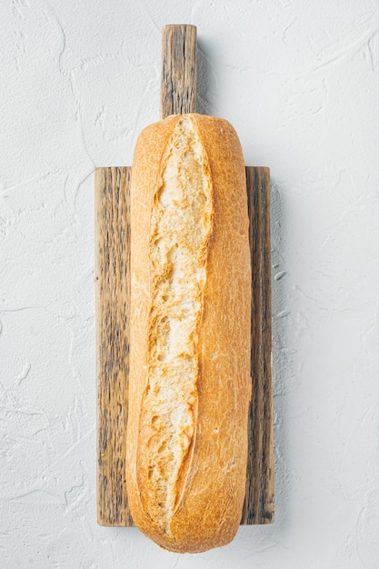 Artisanal baguette bread, on white background, top view flat lay