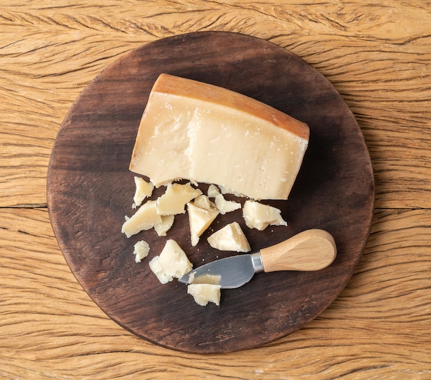 Artisanal Tulha cheese from Brazil with pieces over wooden table