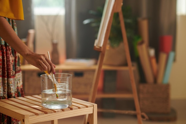 Artist Cleaning Brush in Water