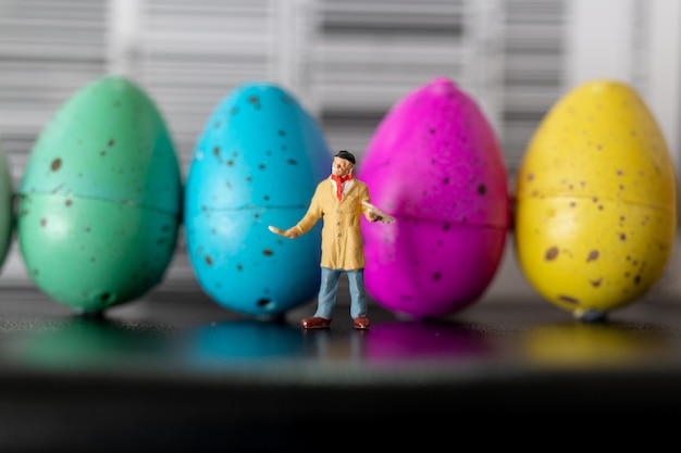 Photo artist is holding a brush and paint easter-eggs