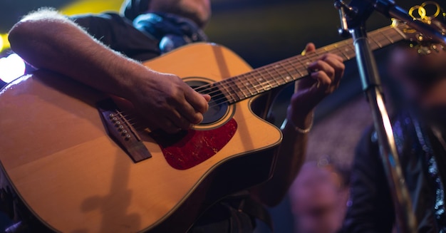 The artist plays the guitar