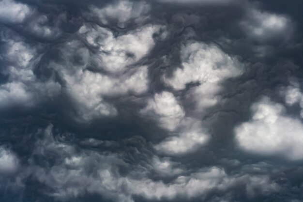 Artistic photo of sky with clouds in black and white colors, abstract nature background design