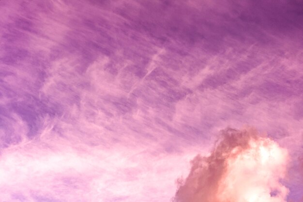 Artistic photo of toned pink sky with clouds, abstract nature background