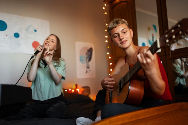 Artists making music in bedroom low angle