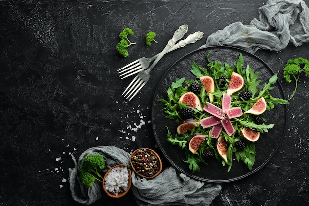 Arugula salad tuna fillet and figs with blackberry berries Menu Free copy space Top view