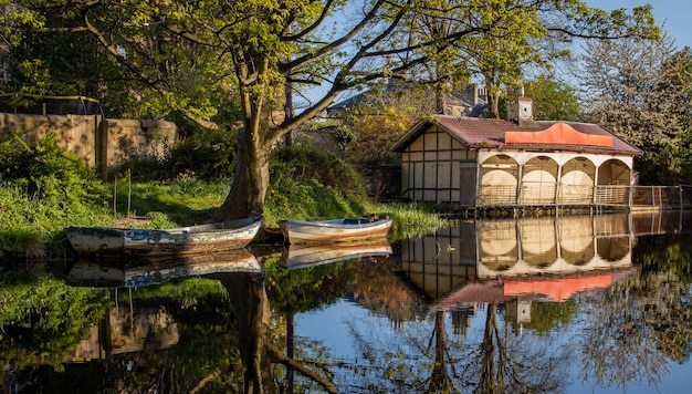 Ashley Terrace Boathouse in Edinburghs Union Canal in the sun with two old rowing boats