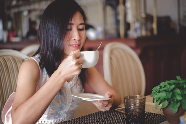 Asia beautiful woman drinking coffee in the coffee shop on holiday.