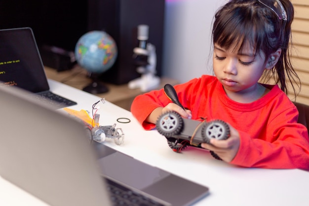 Asia students learn at home in coding robot cars and electronic board cables in STEM STEAM mathematics engineering science technology computer code in robotics for kids concept