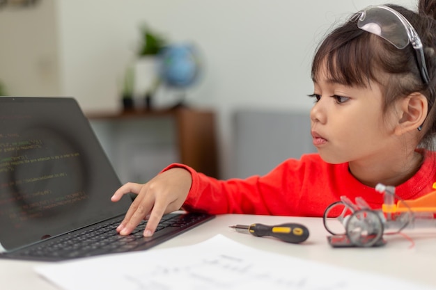 Asia students learn at home in coding robot cars and electronic board cables in STEM STEAM mathematics engineering science technology computer code in robotics for kids concept