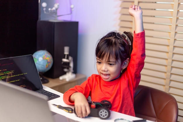 Asia students learn at home in coding robot cars and electronic board cables in STEM STEAM mathematics engineering science technology computer code in robotics for kids concept