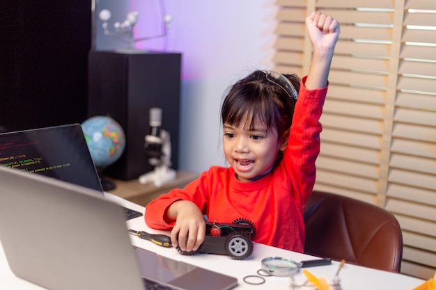 Asia students learn at home in coding robot cars and electronic board cables in STEM STEAM mathematics engineering science technology computer code in robotics for kids concept