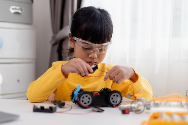 Asia students learn at home in coding robot cars and electronic board cables in STEM STEAM mathematics engineering science technology computer code in robotics for kids concept